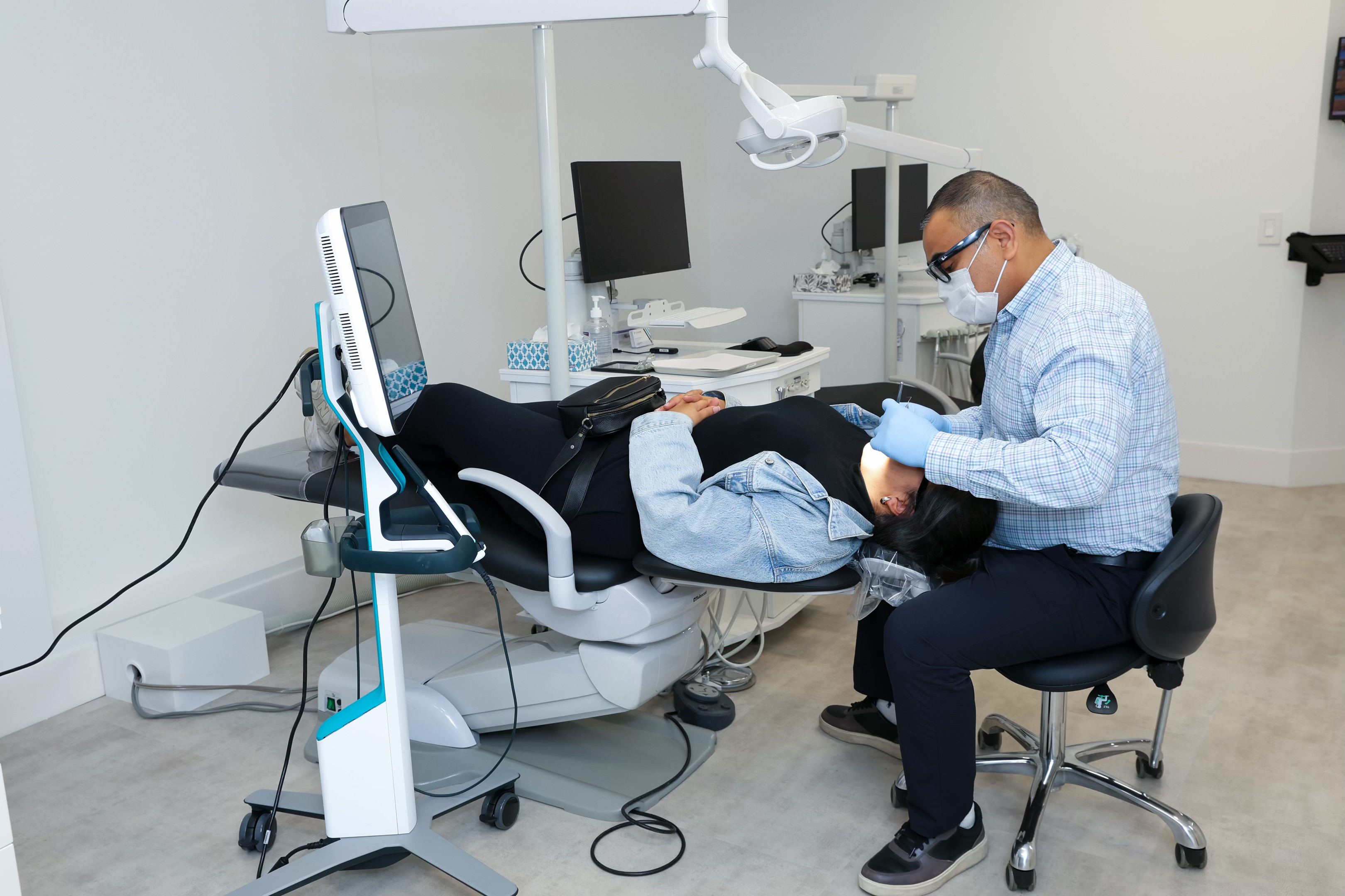 Orthodontist presenting 3D digital oral imaging to patient